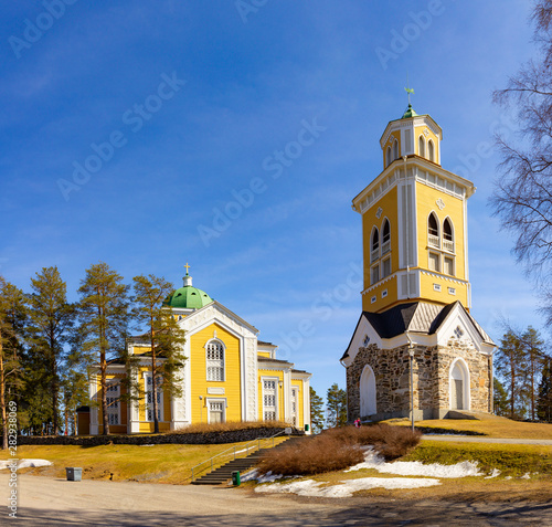 beautiful view of ancient Lutheran Church whith bell tower in kerimaki of southern Savo province on a sunny spring day. The biggest wooden cathedral in Scandinavia and in the world. Eastern Finland photo