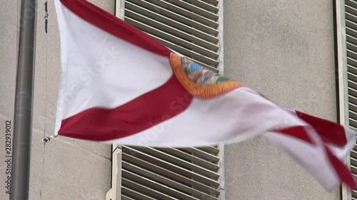 Florida state flag flying in the breeze in front of the state capitol