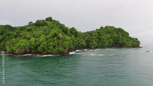 Wallpaper Mural 4K Small tropical green island in the middle of the ocean. Aerial side profile moving right Torontodigital.ca