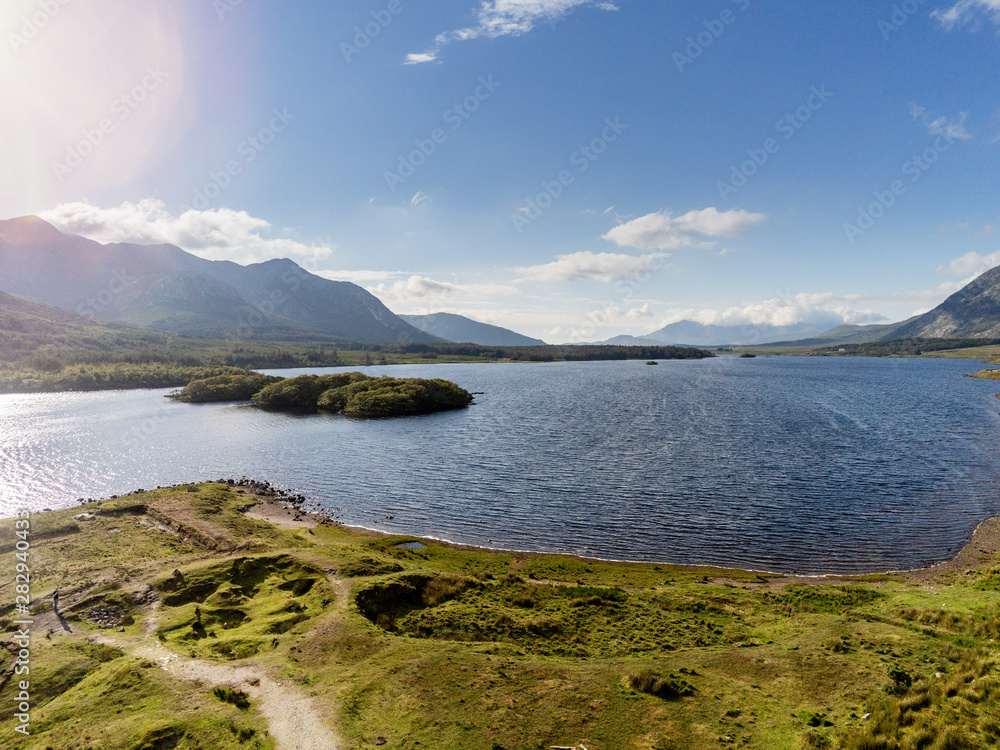 Nature landscape, Connemara national park, Ireland, Lakes with blue water, mountains in the background. Aerial view, Cloudy sky.