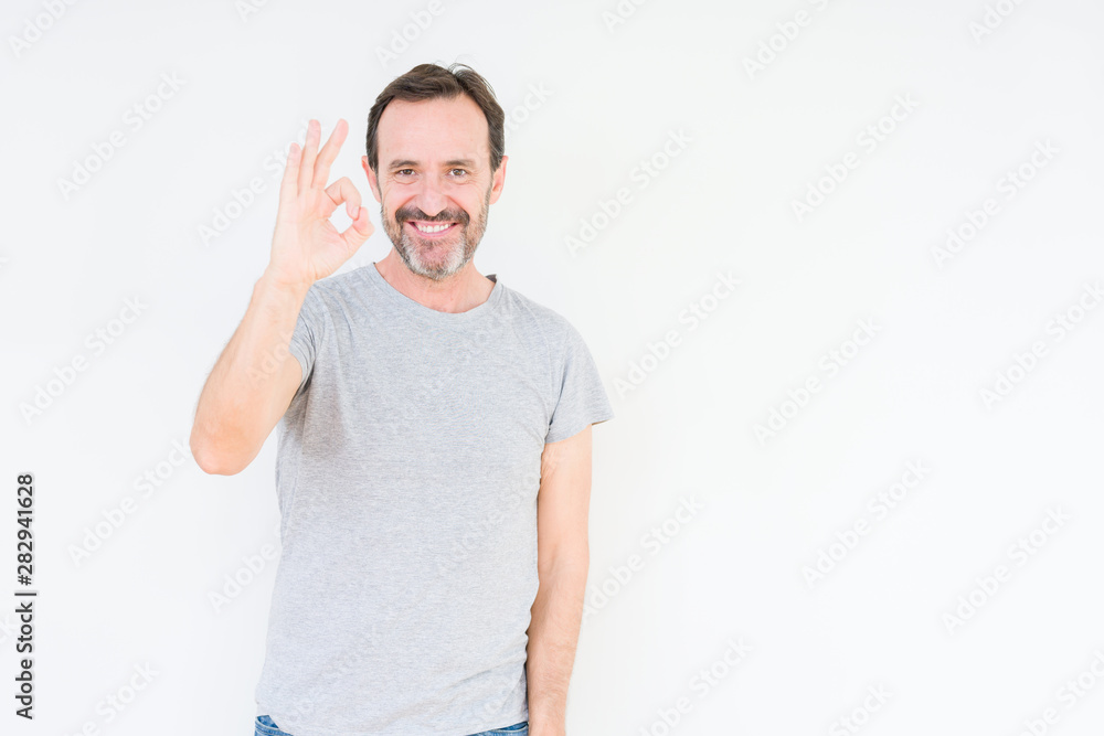 Handsome senior man over isolated background smiling positive doing ok sign with hand and fingers. Successful expression. Handsome senior man over isolated background smiling positive doing ok sign with hand and fingers. Successful expression.