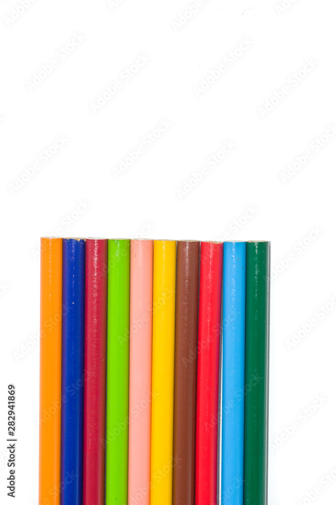 collection of color pencils arranged side by side isolated on white background and copy space; artistic concept collection of color pencils arranged side by side isolated on white background and copy space; artistic concept