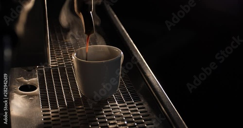 white cup of aromatic espresso made on vintage coffee machine