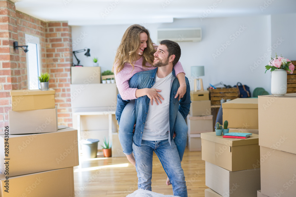 Young couple moving to a new house, boyfriend giving a piggy back ride to girlfriend, very happy and cheerful for new apartment Young couple moving to a new house, boyfriend giving a piggy back ride to girlfriend, very happy and cheerful for new apartment
