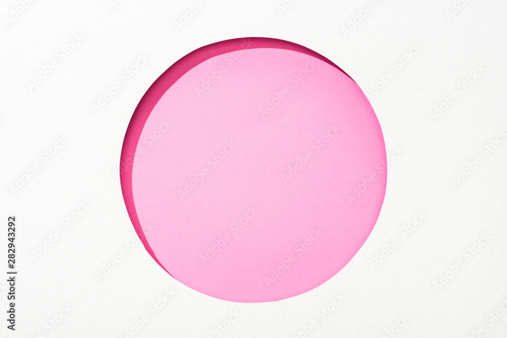 cut out round hole in white paper on pink colorful background