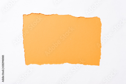 orange colorful background in white torn paper hole