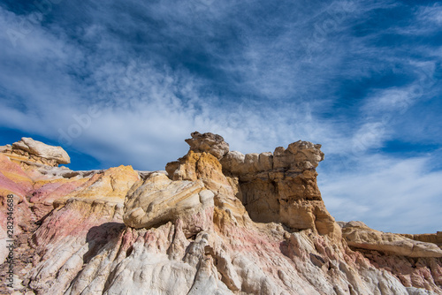 Landscape of white, pink and yellow hoodoos and rock formations at Interpretive Paint Mines in Colorado