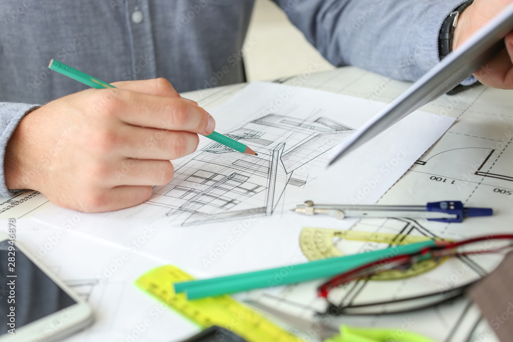 Architect working on project of building in office, closeup Architect working on project of building in office, closeup