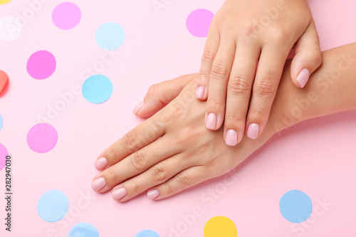 Female hands with beautiful manicure on color background