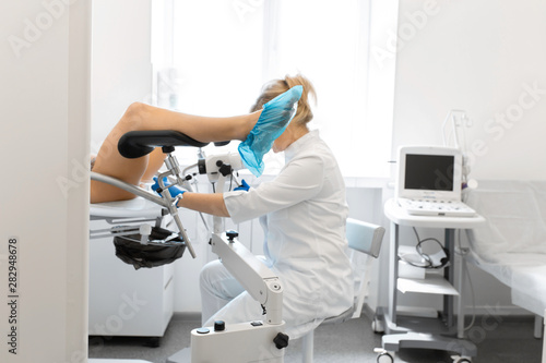 A gynecologist examines a patient on a gynecological chair. Workflow of a gynecologist
