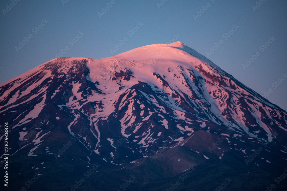 Fototapeta premium Breathtaking sunset on Mount Ararat, Agri Dagi, the highest mountain in the extreme east of Turkey accepted in Christianity as the resting place of Noah's Ark, snow-capped and dormant compound volcano