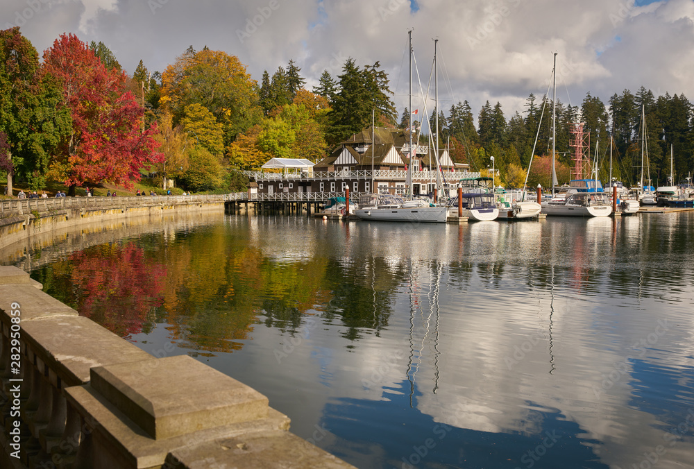 Coal Harbor Autumn Vancouver. Stanley Park fall colours reflect in Coal Harbour by the Vancouver Rowing Club.