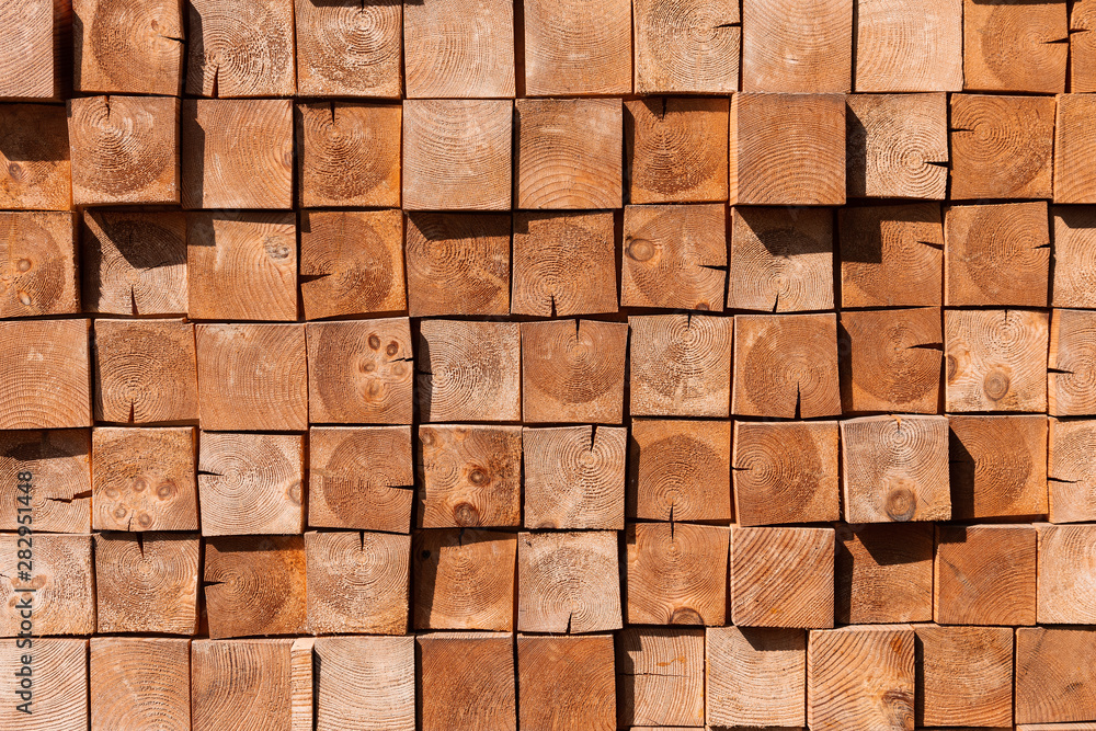 Square wooden blocks background. A wall made of many trees. Cozy