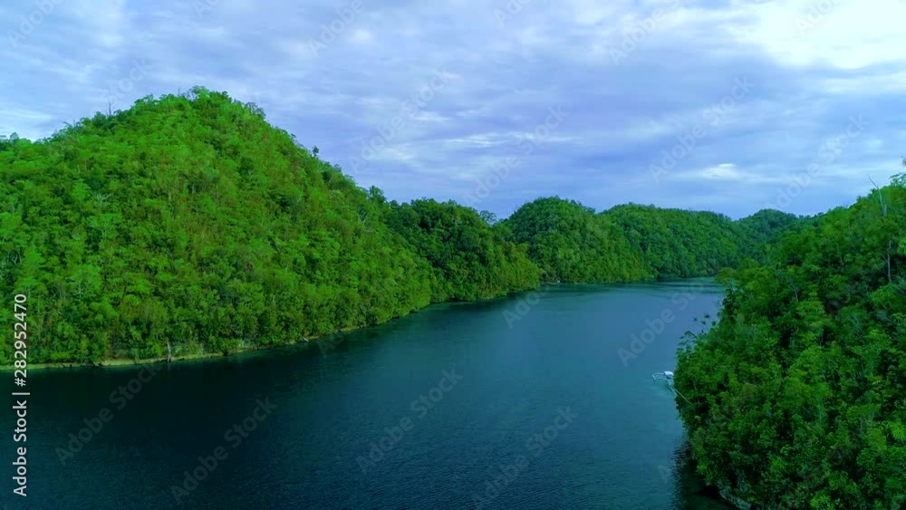 Tropical landscape rainforest hills and azure water in lagoon with clouds on the Siargao island, Philippines. Drone Aerial view 4Kl Tropical landscape rainforest hills and azure water in lagoon with clouds on the Siargao island, Philippines. Drone Aerial view 4Kl
