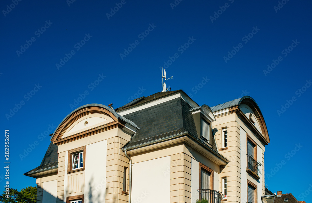 View from below of beautiful luxury house with clear blue sky in the background View from below of beautiful luxury house with clear blue sky in the background
