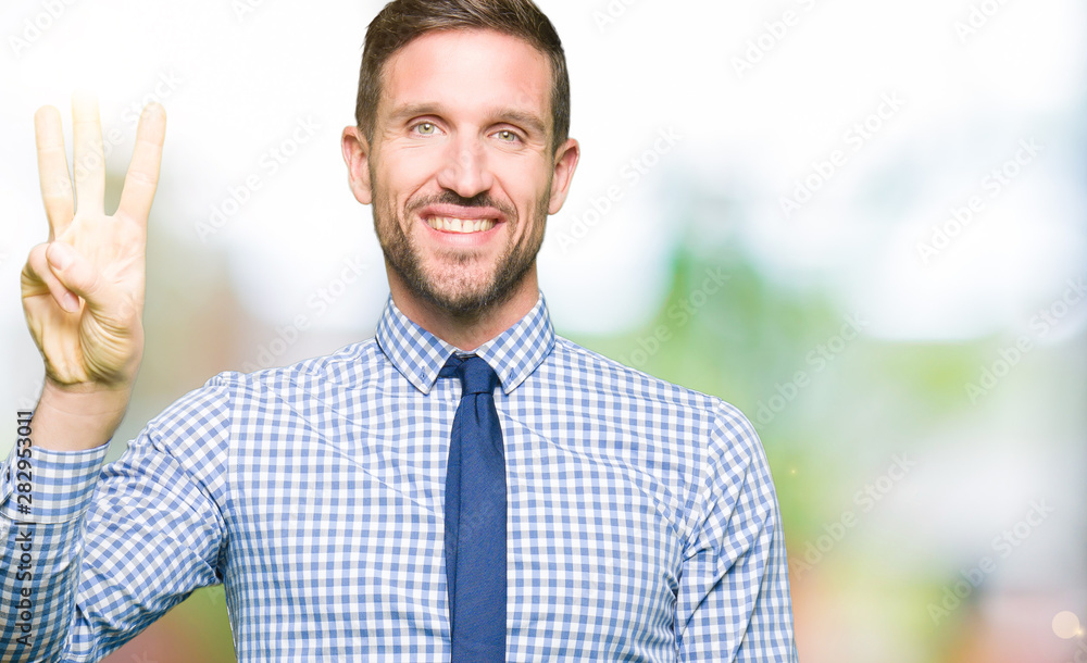 Handsome business man wearing tie showing and pointing up with fingers number three while smiling confident and happy. Handsome business man wearing tie showing and pointing up with fingers number three while smiling confident and happy.