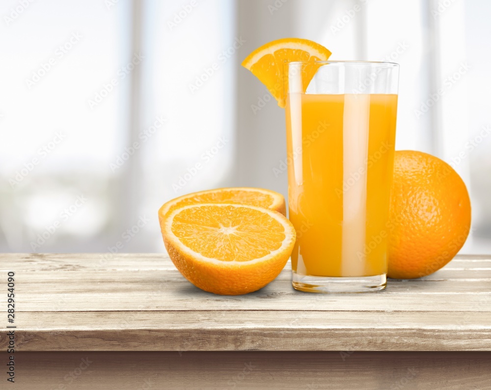 Naklejka premium Orange Juice in glass on background.