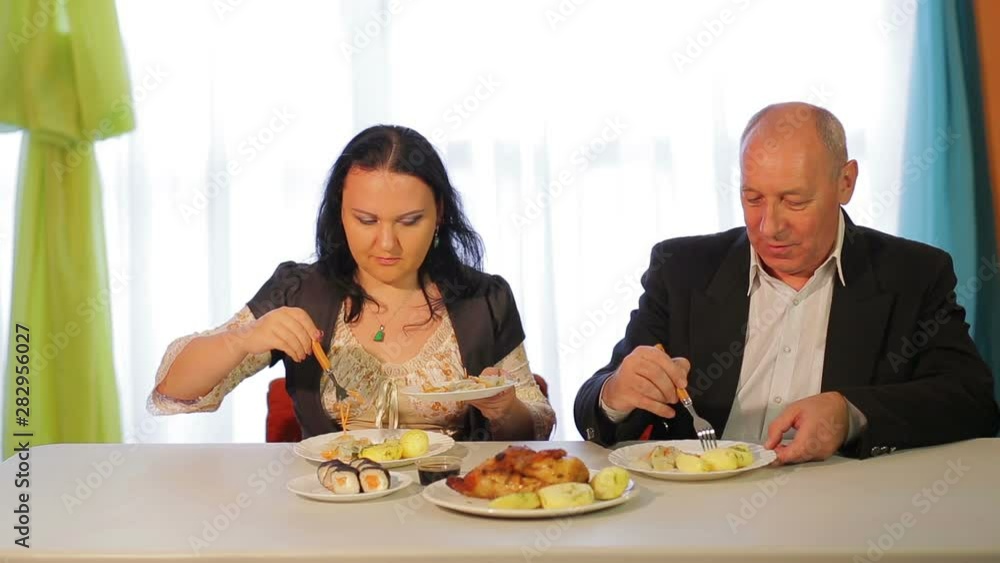 A man and a woman during a business lunch have lunch and discuss business. A man and a woman during a business lunch have lunch and discuss business.