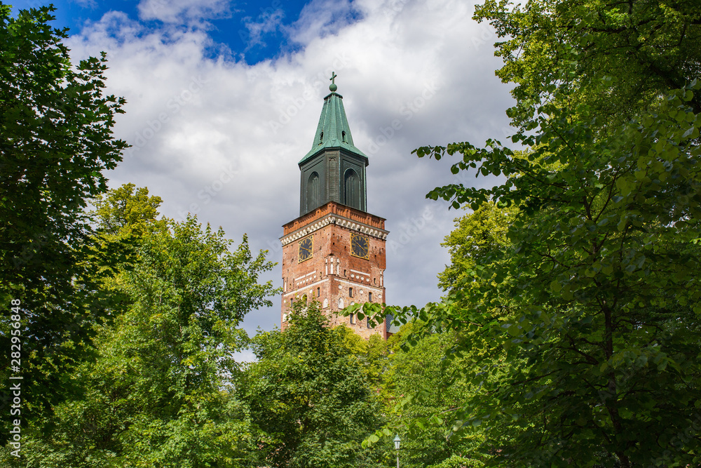 Medieval Turku Cathedral clock tower surrounded by greenery on beautiful summer day in Finland. Medieval Turku Cathedral clock tower surrounded by greenery on beautiful summer day in Finland.