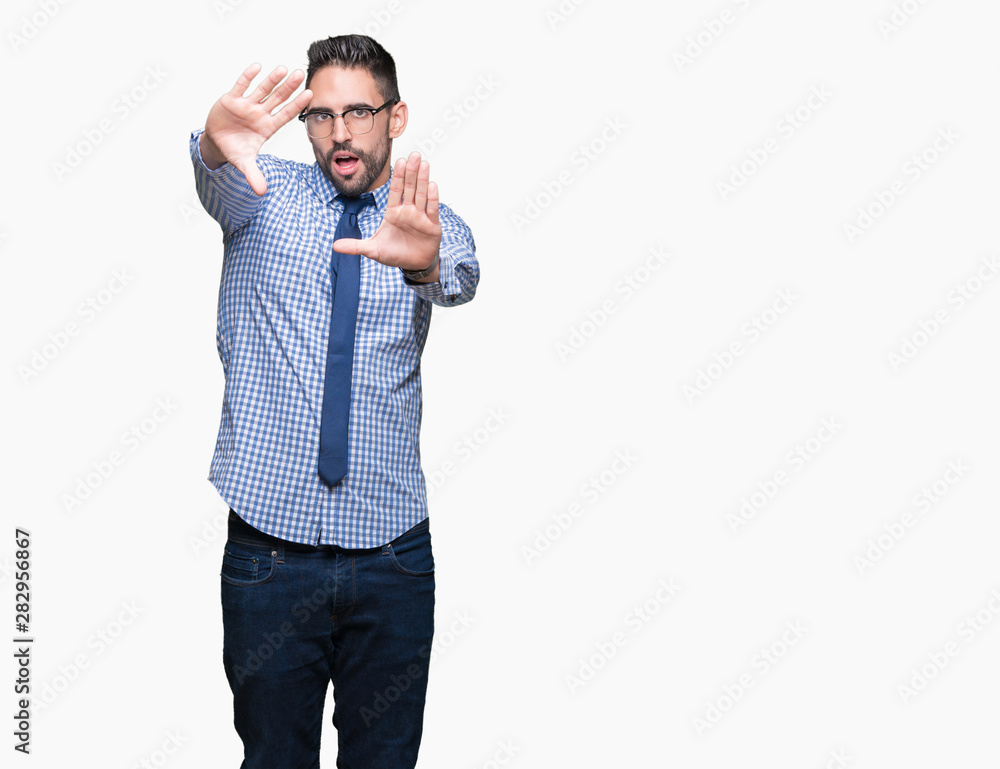 Young business man wearing glasses over isolated background Smiling doing frame using hands palms and fingers, camera perspective Young business man wearing glasses over isolated background Smiling doing frame using hands palms and fingers, camera perspective