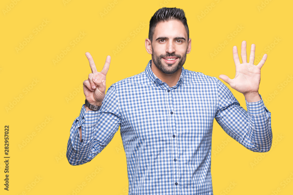 Young handsome man over isolated background showing and pointing up with fingers number seven while smiling confident and happy. Young handsome man over isolated background showing and pointing up with fingers number seven while smiling confident and happy.