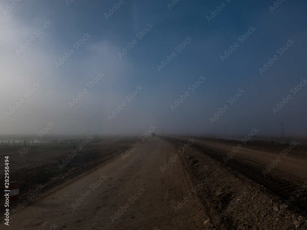 Rural way landscape with fog 