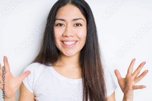 Wallpaper Mural Beautiful brunette woman over isolated background celebrating crazy and amazed for success with arms raised and open eyes screaming excited. Winner concept Torontodigital.ca