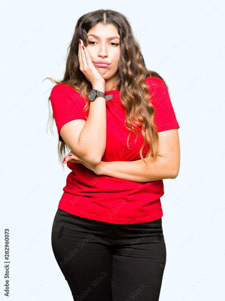 Young beautiful woman wearing casual t-shirt thinking looking tired and bored with depression problems with crossed arms. Young beautiful woman wearing casual t-shirt thinking looking tired and bored with depression problems with crossed arms.