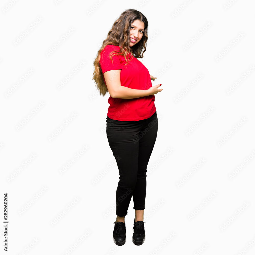 Young beautiful woman wearing casual t-shirt Inviting to enter smiling natural with open hand Young beautiful woman wearing casual t-shirt Inviting to enter smiling natural with open hand