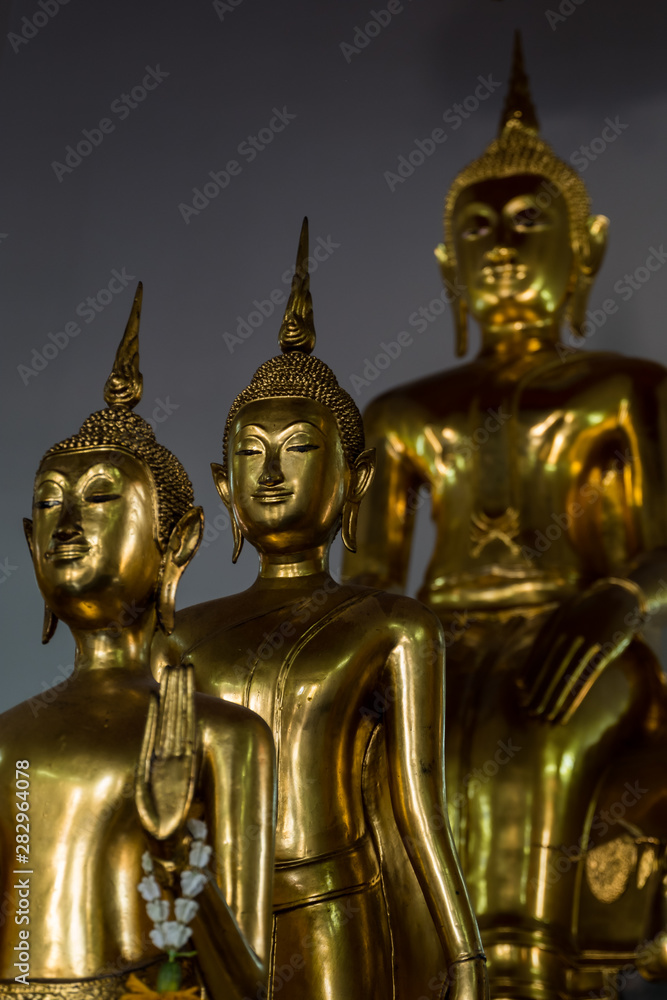 Golden Buddha statues inside Asian temple Golden Buddha statues inside Asian temple