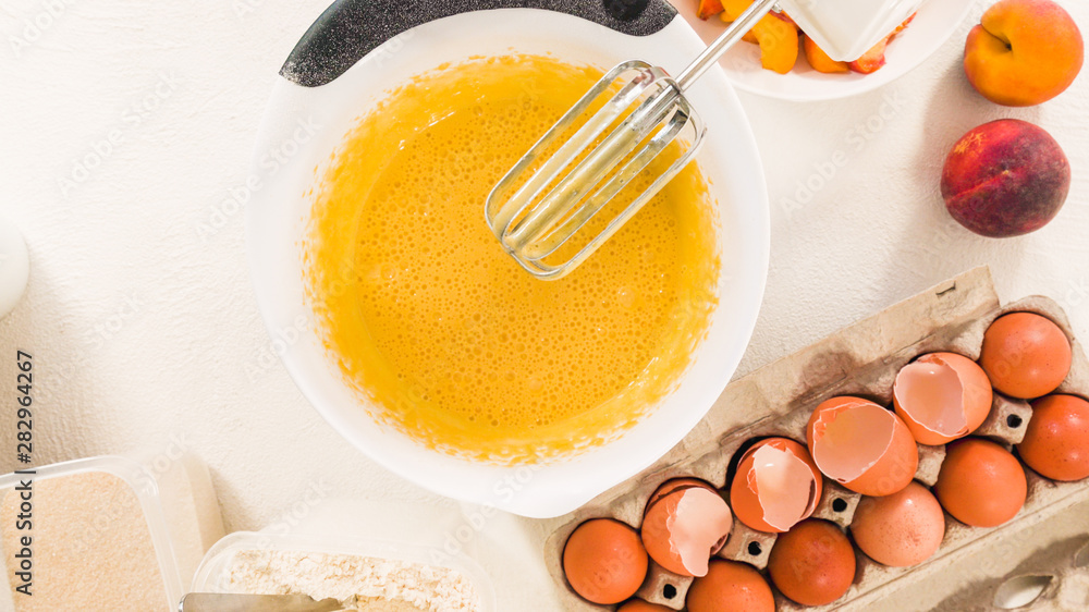 Baking Cake with Dough Recipe Ingredients and Fresh Peaches. Top View, White Background Baking Cake with Dough Recipe Ingredients and Fresh Peaches. Top View, White Background
