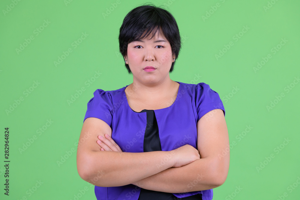 Young beautiful overweight Asian woman with arms crossed Young beautiful overweight Asian woman with arms crossed