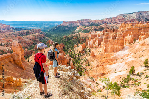 Tableau sur toile Family hiking in Bryce Canyon National Park, Utah, USA looking out at a scenic v