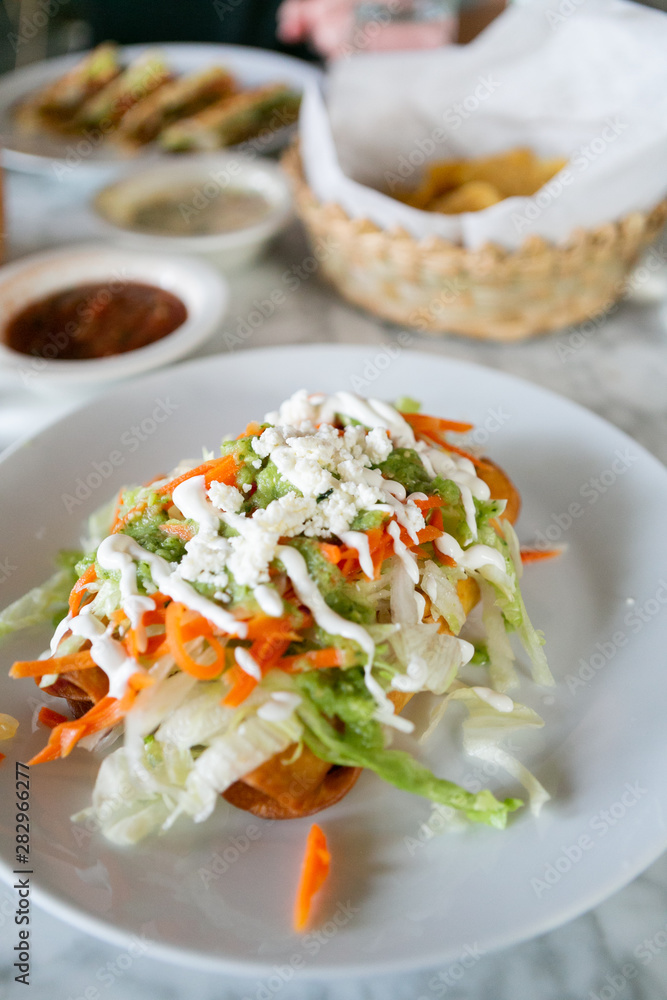 Flautas, 3 flour tortillas rolled with chipotle chicken, lettuce, tomatillo avocado salsa, pickled carrots, queso fresco, crema, taquitos Flautas, 3 flour tortillas rolled with chipotle chicken, lettuce, tomatillo avocado salsa, pickled carrots, queso fresco, crema, taquitos