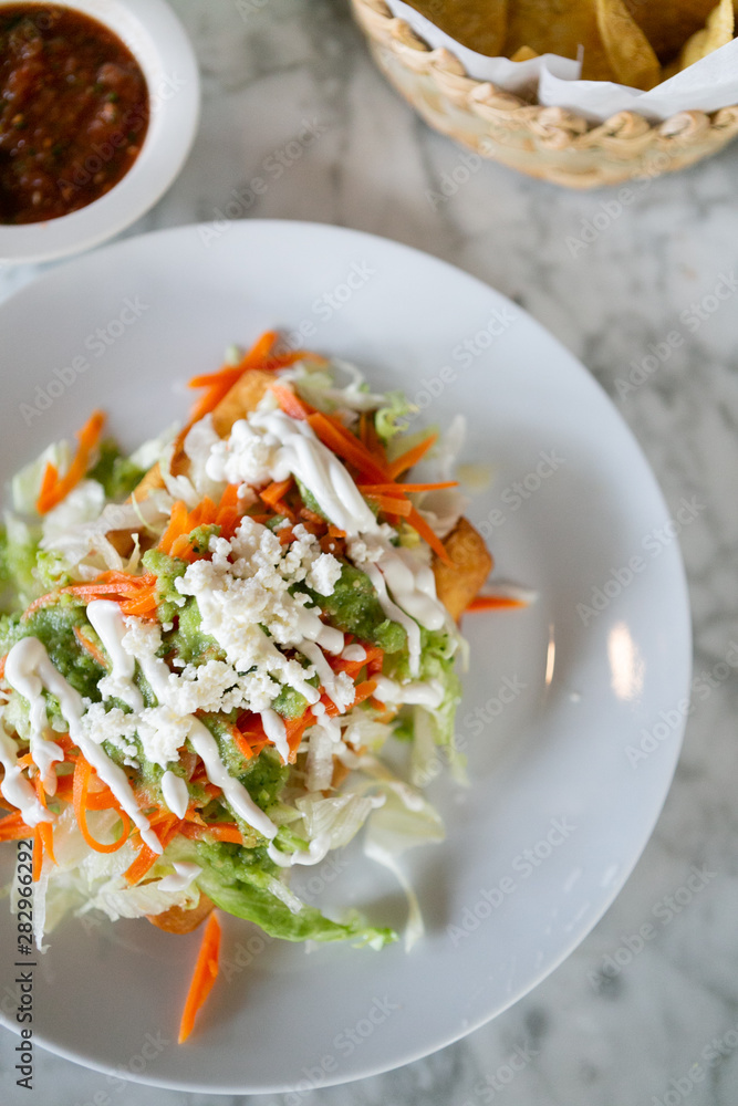 Flautas, 3 flour tortillas rolled with chipotle chicken, lettuce, tomatillo avocado salsa, pickled carrots, queso fresco, crema, taquitos Flautas, 3 flour tortillas rolled with chipotle chicken, lettuce, tomatillo avocado salsa, pickled carrots, queso fresco, crema, taquitos