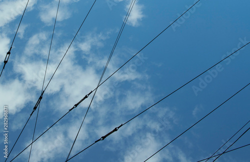 Abstract pattern using power lines, shining sky and clouds