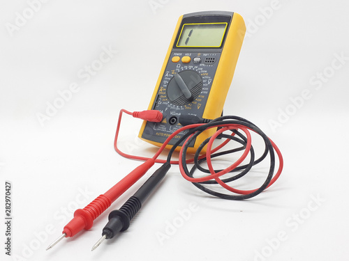 Yellow Modern Digital Electronic Multi Meter with Ohm Ampere Volt and Watt Measurement with Red and Black Probe in White Isolated Background