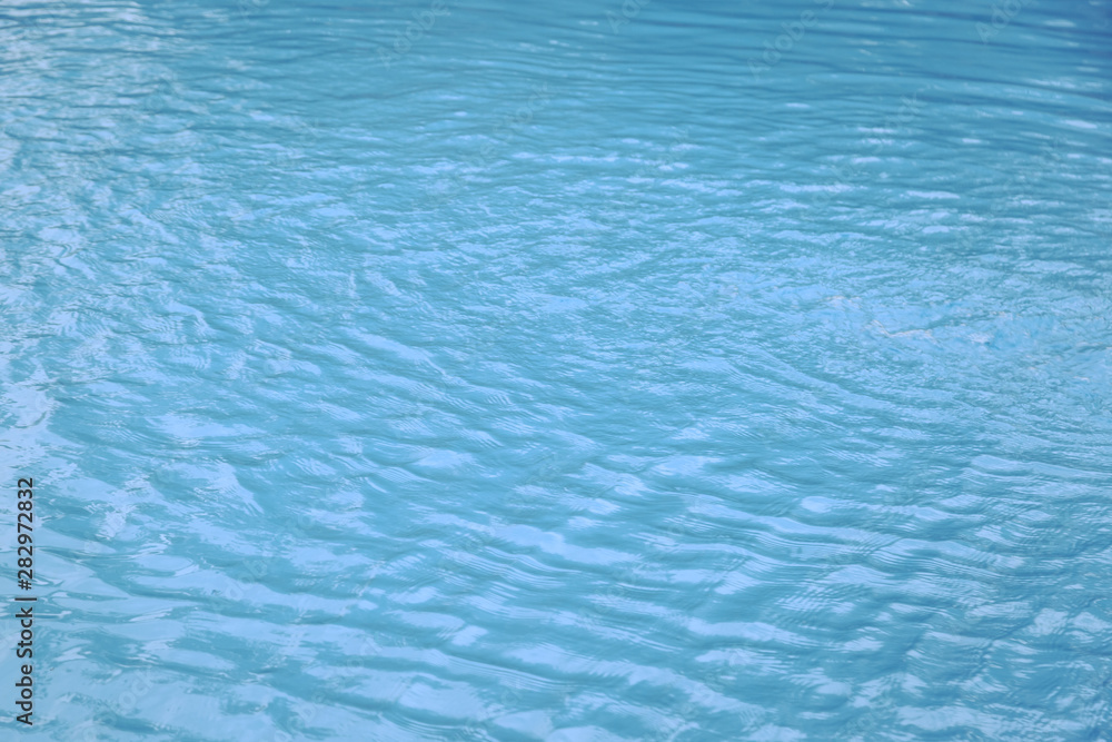 Blue swimming pool edge with refection of water ripple Blue swimming pool edge with refection of water ripple