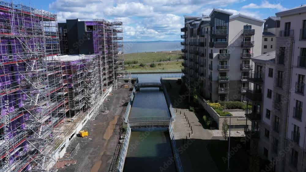 Flying Between Two Buildings on a Construction Site. One Building ...