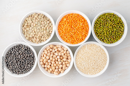 Different types of legumes in small pussies on a white background © Artur Lans