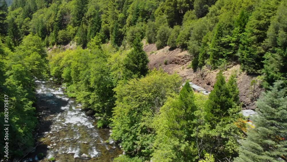 Train winding through the mountain forest near a river. Train winding through the mountain forest near a river.