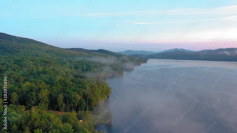 Aerial Hyper-lapse mist dissipates over pine trees Golden Hour Lake 4K Aerial Hyper-lapse mist dissipates over pine trees Golden Hour Lake 4K