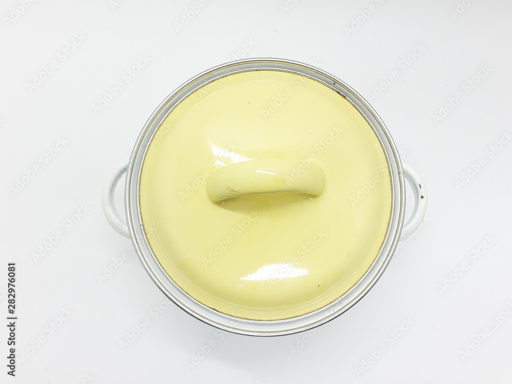White Artistic Metallic Boiling Pan with Floral Ornaments and Yellow Cap for Kitchen Utensils in White Isolated Background White Artistic Metallic Boiling Pan with Floral Ornaments and Yellow Cap for Kitchen Utensils in White Isolated Background