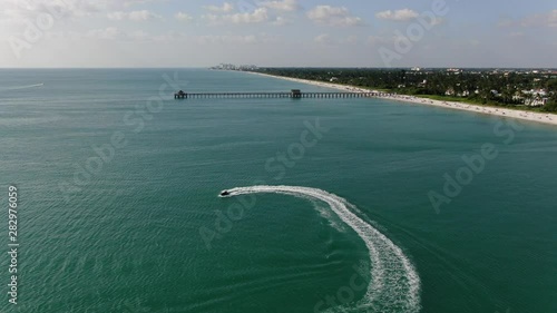 drone aerial of a jet ski in the water by the Naples Fishing Pier photo