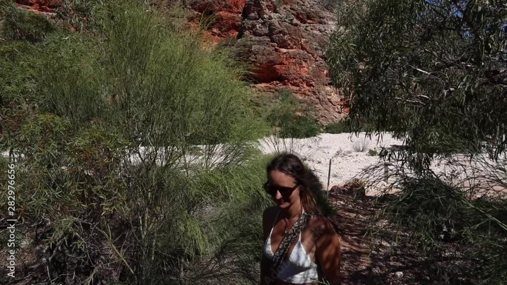 Young woman walking on outback track in Australia Young woman walking on outback track in Australia
