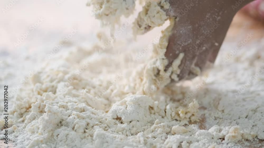 Kids hands preparing dough for pizza or bread on table, slow motion. Kids hands preparing dough for pizza or bread on table, slow motion.
