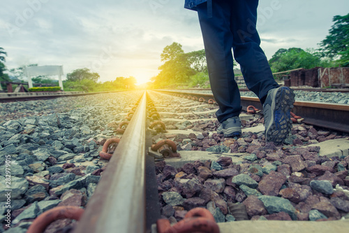 Pathway to success concept a man walk on the railroad  go to the light at the destination  with space area for write some text on background meaning walk to success concept