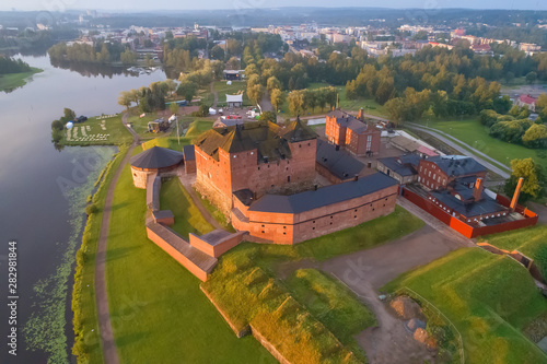 Ancient fortress in a cityscape in the early July morning (aerial photography). Hameenlinna, Finland photo