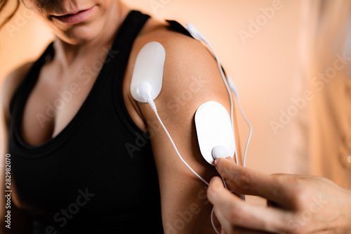 Photos Shoulder Physical Therapy with TENS Electrode Pads, Transcutaneous Electrical Ne