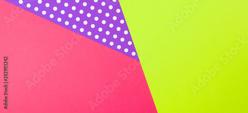 Abstract geometric yellow  purple and pink polka dot paper background.
